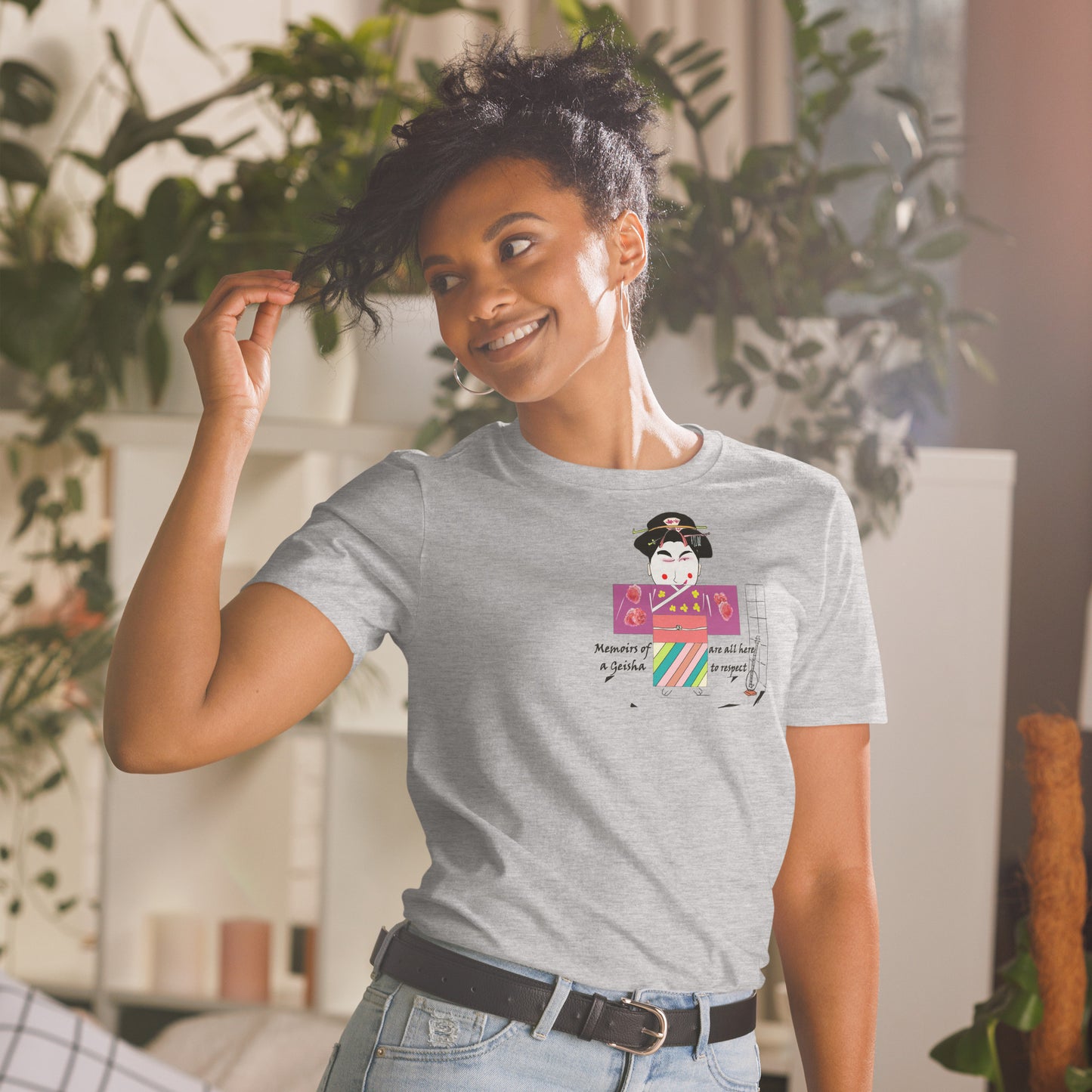 Front view of a lady model wearing a gray t-shirt with a Japanese Geisha graphic design on a home background with plants