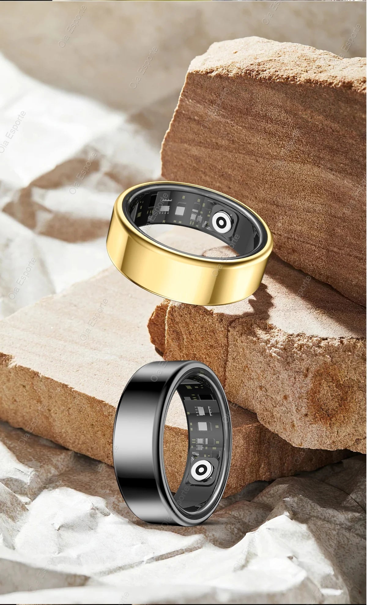 Two smart rings, one gold and one silver, on a rock with water in the background.