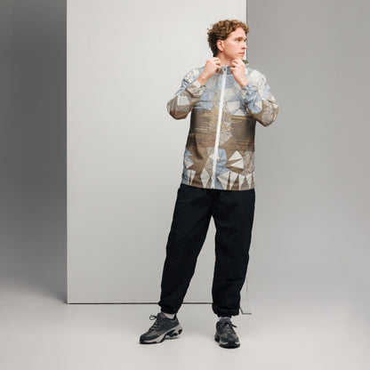 Person wearing an abstract patterned jacket and black pants against a gray background