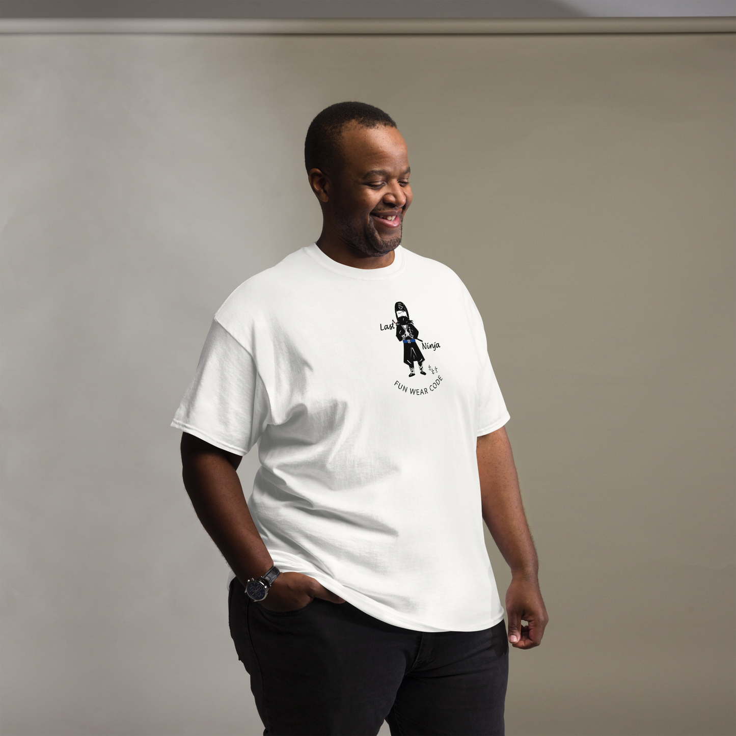 Man wearing a white t-shirt with a playful "Last Ninja" graphic design and text "FUN WEAR CODE" on a plain background