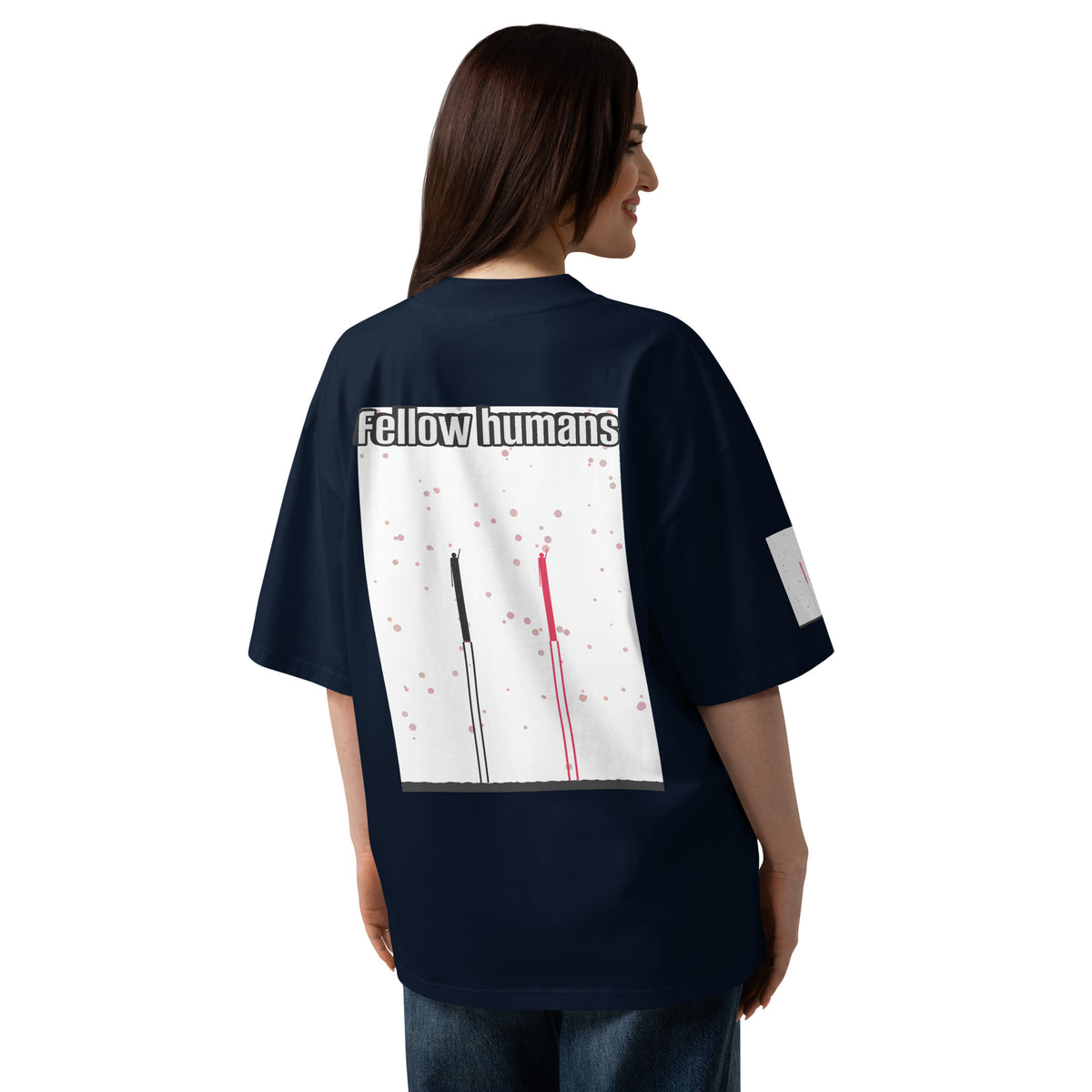 Person wearing a navy blue t-shirt with a graphic design on the back, featuring the text 'Fellow humans'.